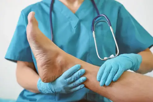 Hand of Doctor holding patient's leg, examination of patients in the hospital.